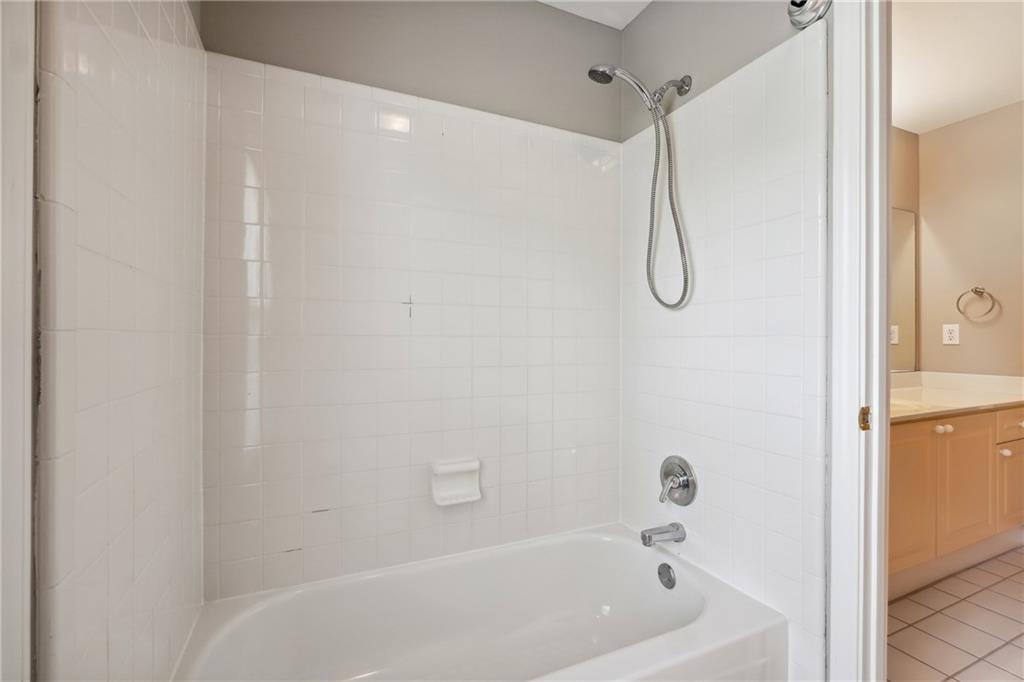 5145 Harbour Ridge Drive Alpharetta, GA 30005 - Photo 19 of 27 a bathroom with a bath tub with a shower