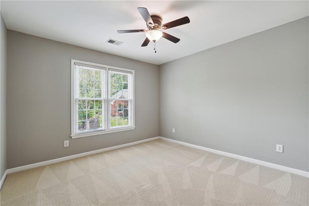 5145 Harbour Ridge Drive Alpharetta, GA 30005 - Photo 20 of 27 an empty room with windows and fan