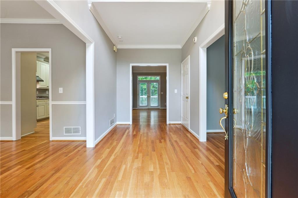 5145 Harbour Ridge Drive Alpharetta, GA 30005 - Photo 2 of 27 a view of a hallway with wooden floor and closet area