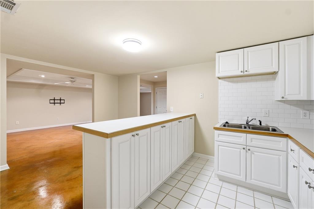 5145 Harbour Ridge Drive Alpharetta, GA 30005 - Photo 21 of 25 a kitchen with white cabinets and sink