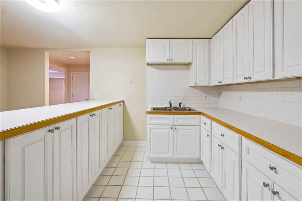 5145 Harbour Ridge Drive Alpharetta, GA 30005 - Photo 22 of 27 a kitchen with white cabinets