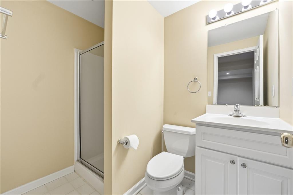 5145 Harbour Ridge Drive Alpharetta, GA 30005 - Photo 23 of 25 a bathroom with a toilet a sink a mirror and vanity