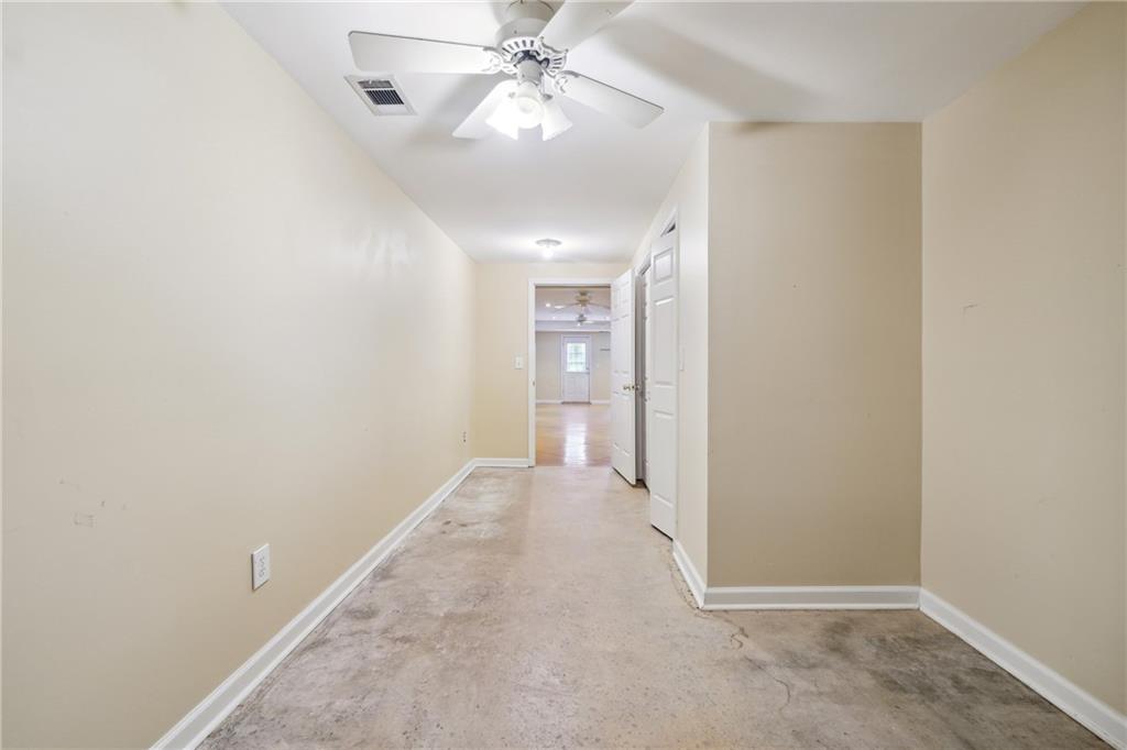 5145 Harbour Ridge Drive Alpharetta, GA 30005 - Photo 25 of 27 an empty room with fan and entrance