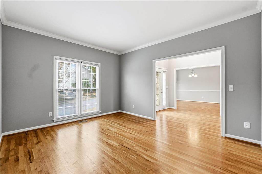 5145 Harbour Ridge Drive Alpharetta, GA 30005 - Photo 3 of 25 a view of an empty room with wooden floor and a window