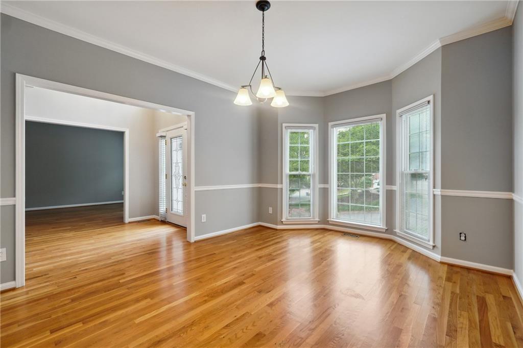 5145 Harbour Ridge Drive Alpharetta, GA 30005 - Photo 3 of 27 a view of an empty room with wooden floor and a window