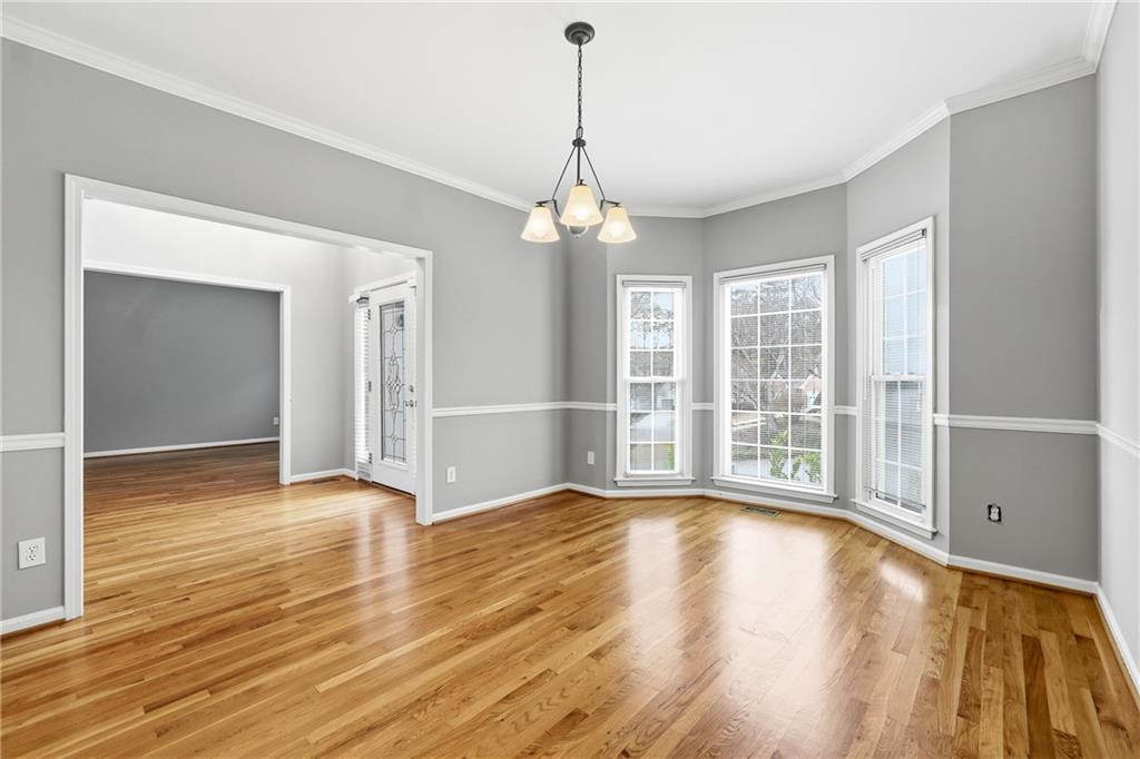 5145 Harbour Ridge Drive Alpharetta, GA 30005 - Photo 4 of 25 a view of an empty room with wooden floor and a window