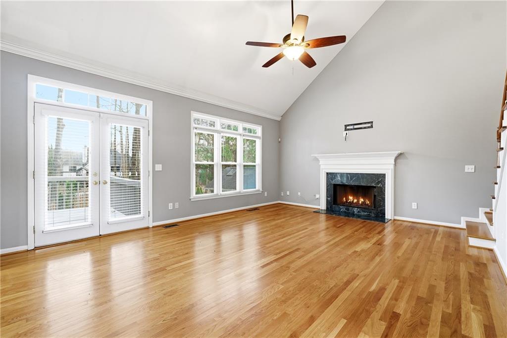 5145 Harbour Ridge Drive Alpharetta, GA 30005 - Photo 5 of 25 wooden floor fireplace and natural light in room