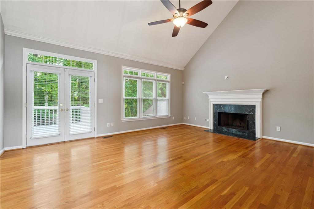 5145 Harbour Ridge Drive Alpharetta, GA 30005 - Photo 5 of 27 a view of an empty room with wooden floor and a window