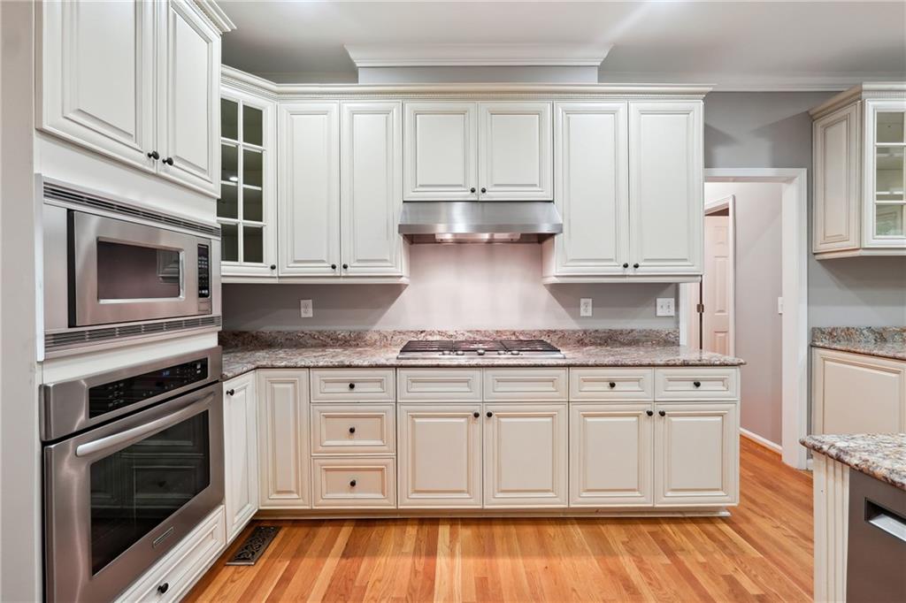5145 Harbour Ridge Drive Alpharetta, GA 30005 - Photo 10 of 27 a kitchen with stainless steel appliances granite countertop a stove a sink and a refrigerator
