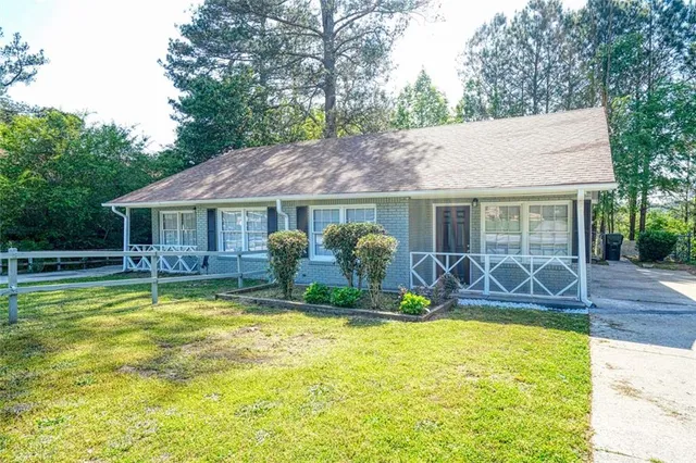 a house view with swimming pool and wooden fence