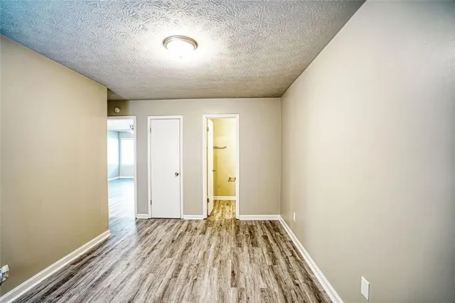 a view of room with window and wooden floor
