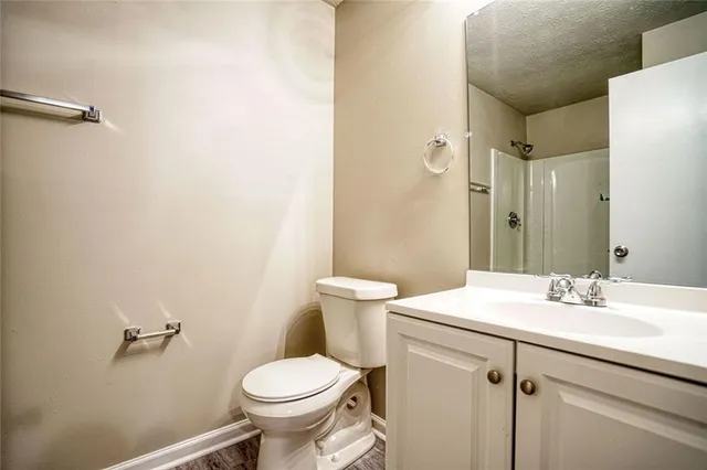 a bathroom with a sink toilet and a mirror