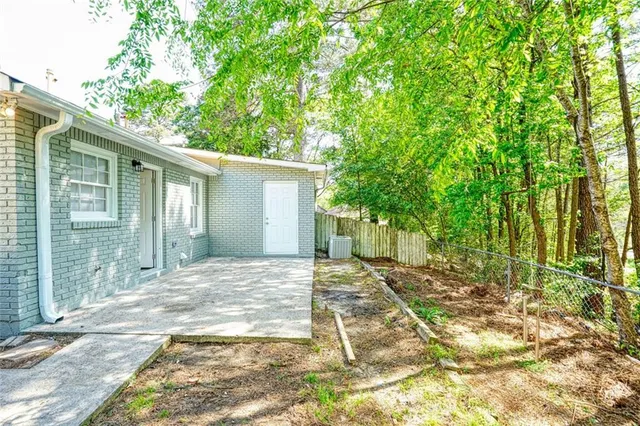 a view of backyard of house with green space