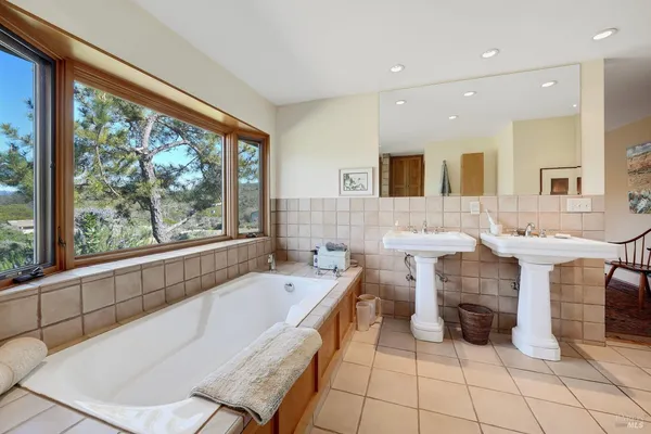 a bathroom with a sink bathtub and a mirror
