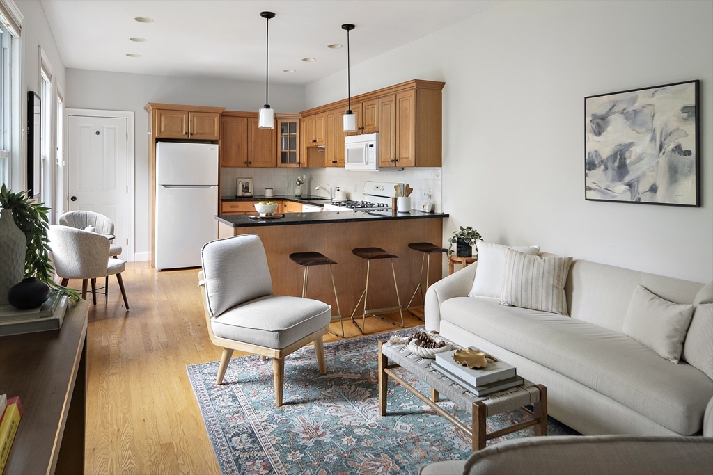 28 Summer Street, Unit 1 Somerville, MA 02143 - Photo 2 of 14 a living room with furniture and kitchen view