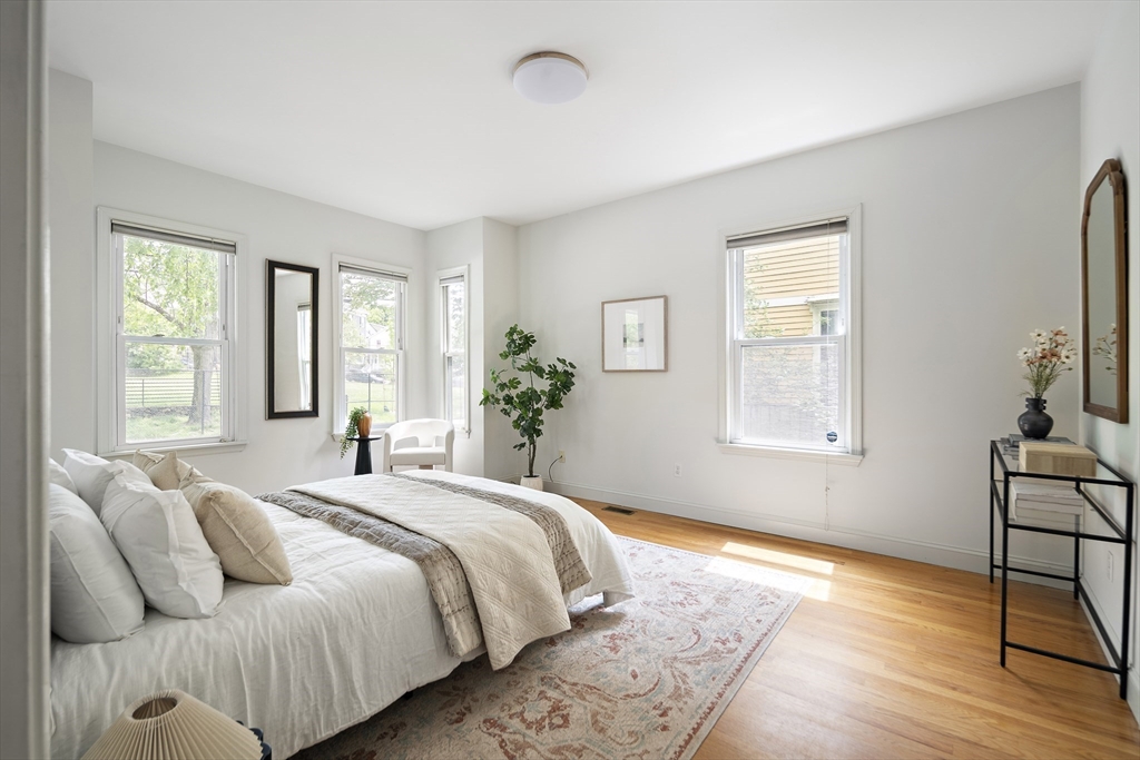 28 Summer Street, Unit 1 Somerville, MA 02143 - Photo 7 of 14 a spacious bedroom with a bed and a window