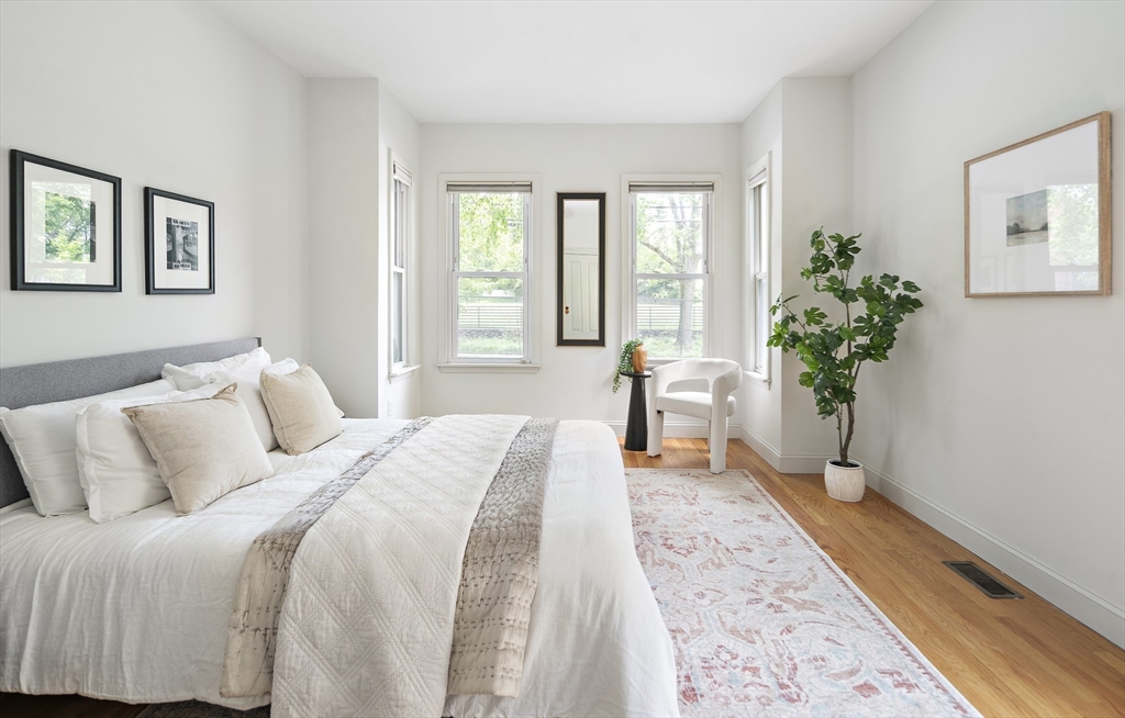 28 Summer Street, Unit 1 Somerville, MA 02143 - Photo 8 of 14 a spacious bedroom with a bed and a potted plant