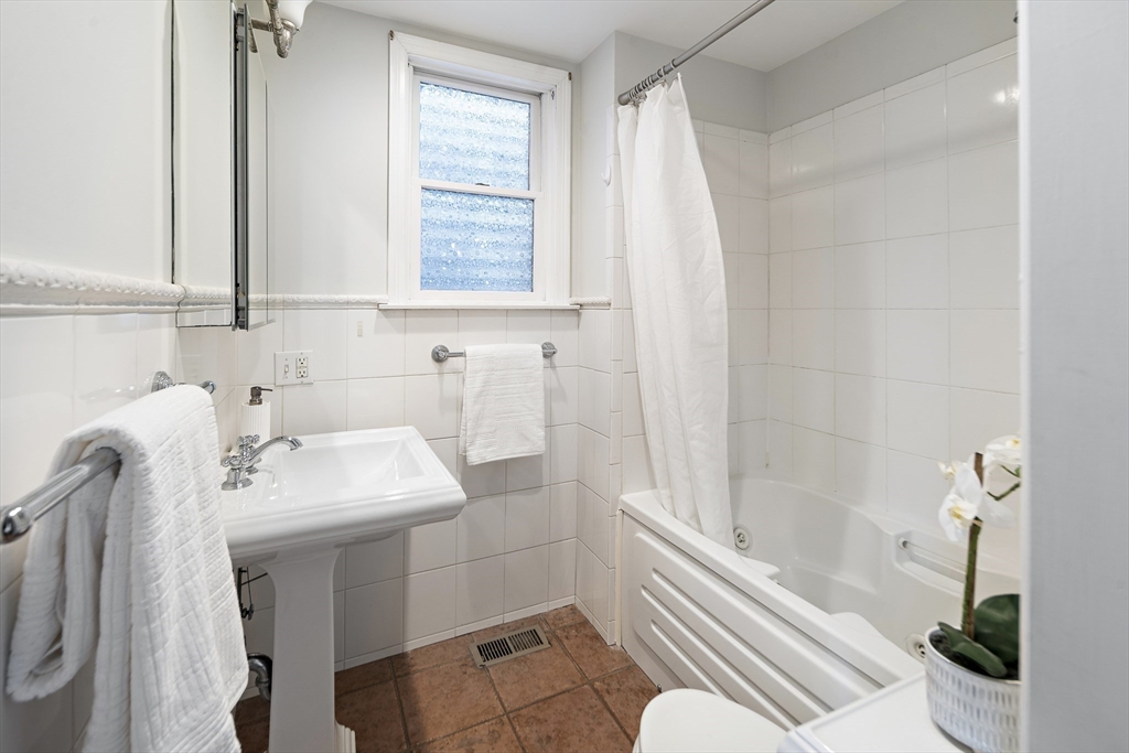 28 Summer Street, Unit 1 Somerville, MA 02143 - Photo 10 of 14 a bathroom with a sink toilet and shower