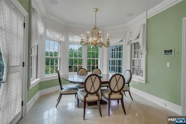 a view of a dining room with furniture wooden floor and chandelier