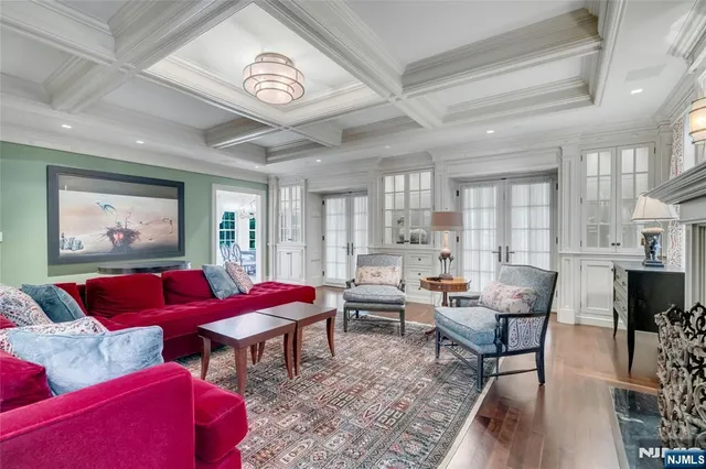 a living room with furniture a rug and a large window