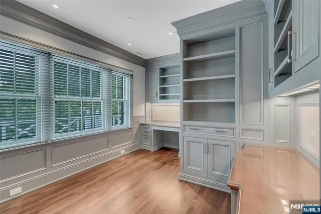 a hallway with cabinets and wooden floor