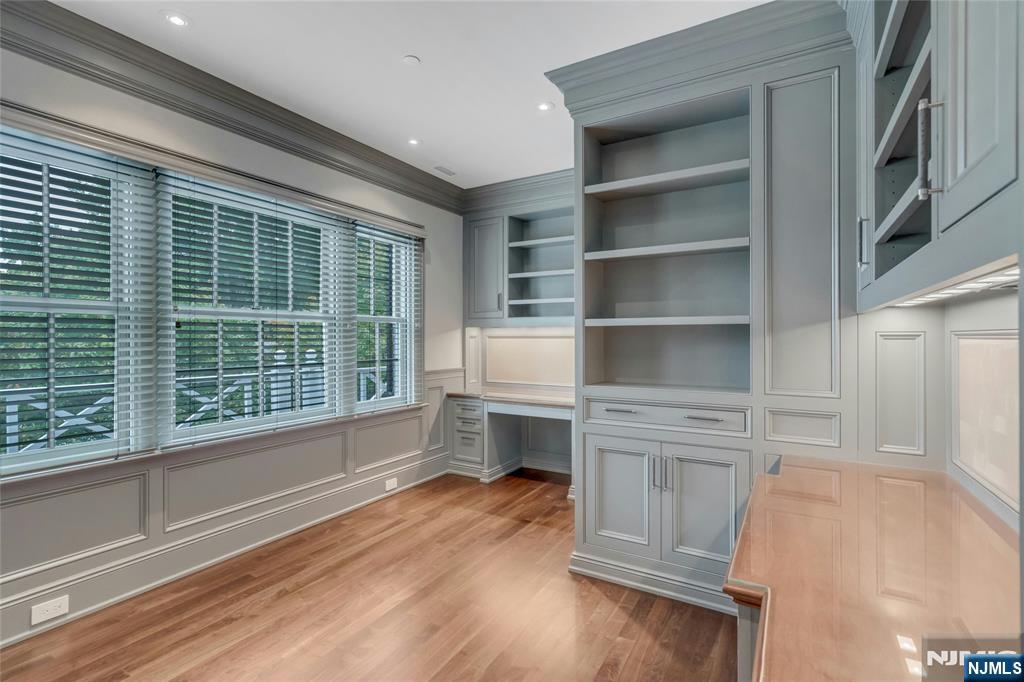 480 Knollwood Road Ridgewood, NJ 07450 - Photo 21 of 50 a hallway with cabinets and wooden floor