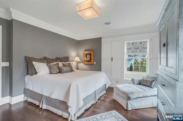 a bedroom with bed and windows