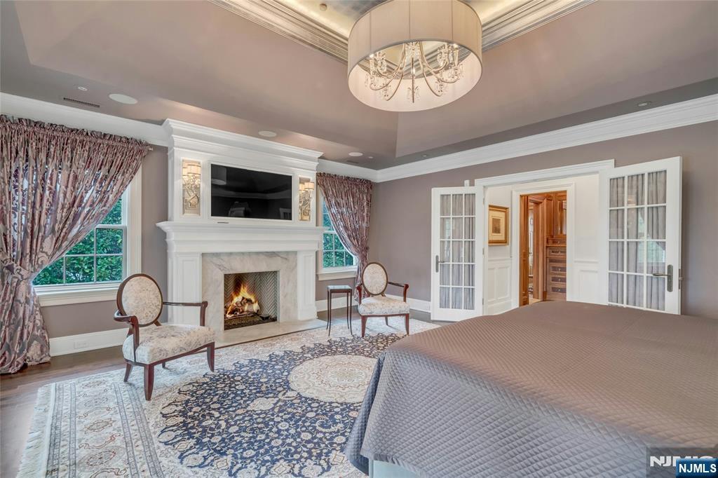 480 Knollwood Road Ridgewood, NJ 07450 - Photo 25 of 50 a living room with furniture a fireplace and a flat screen tv