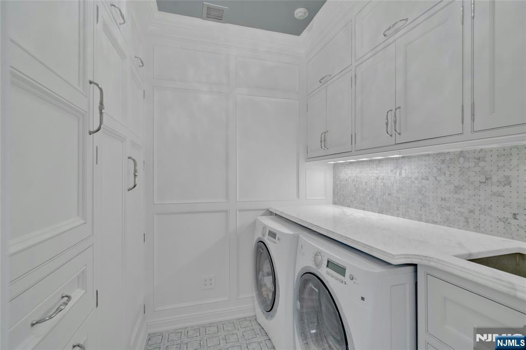 480 Knollwood Road Ridgewood, NJ 07450 - Photo 26 of 50 a utility room with cabinets washer and dryer