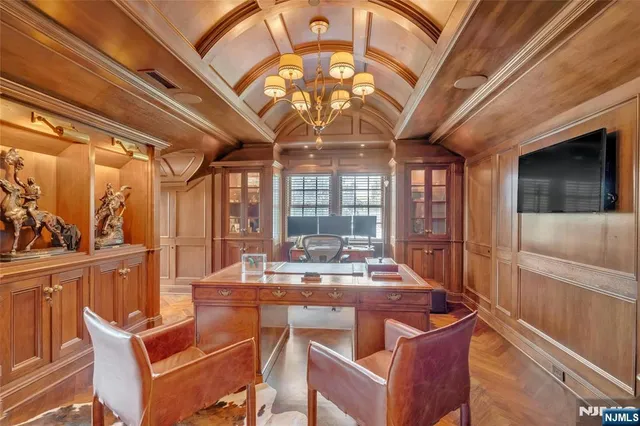 a dining room with wooden floor and furniture