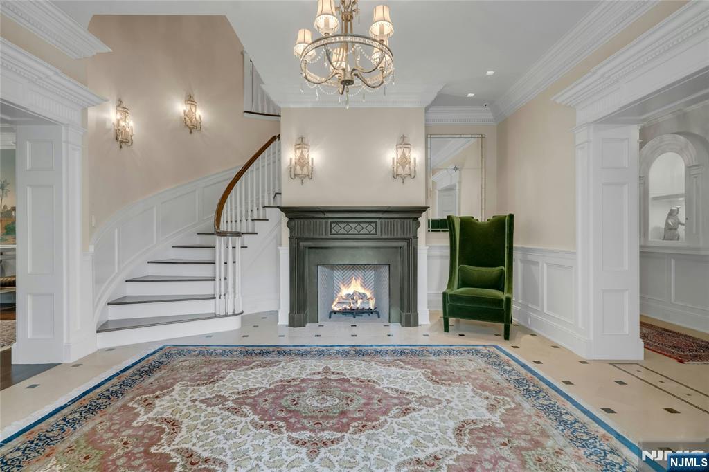480 Knollwood Road Ridgewood, NJ 07450 - Photo 4 of 50 an empty room with a fireplace and lots of wooden floor