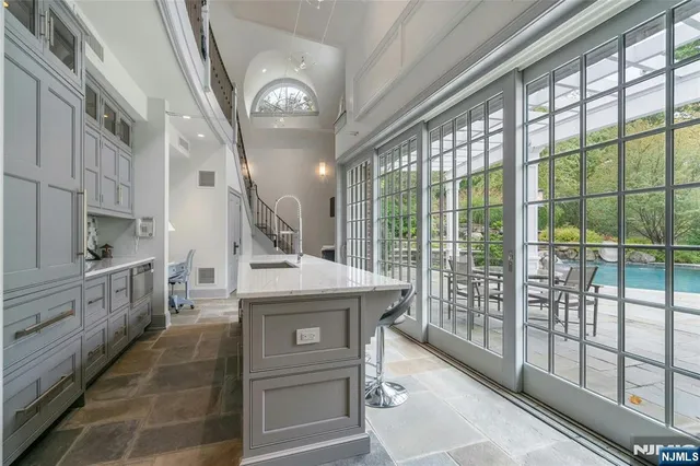 a kitchen with counter top space and windows