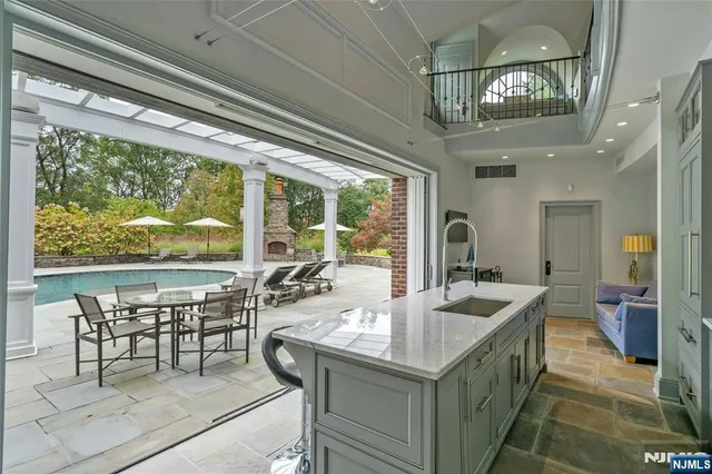 a view of a dining room with furniture large window and chandelier