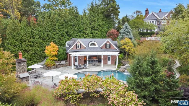an aerial view of a house with yard swimming pool and outdoor seating