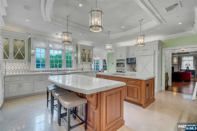 a kitchen with stainless steel appliances granite countertop a kitchen island a stove and a sink