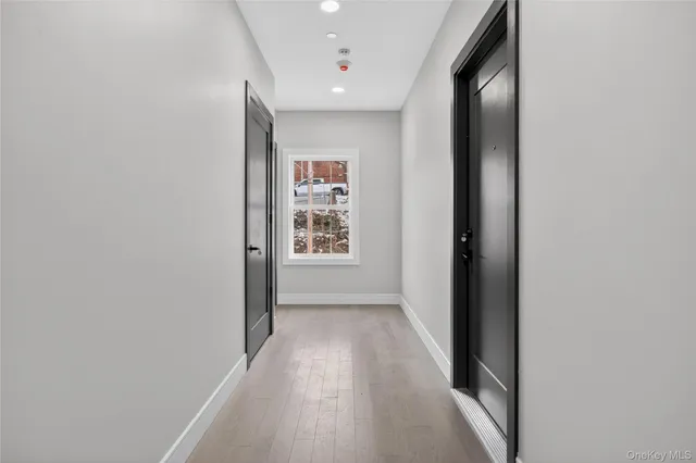 a view of a hallway with wooden floor