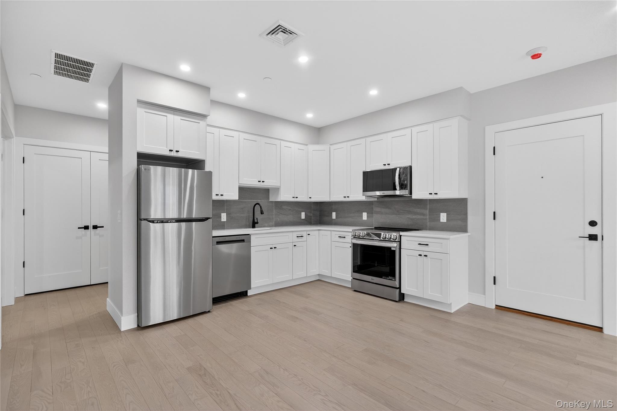 10 Market Street, Unit G Wappingers Falls, NY 12590 - Photo 3 of 20 a kitchen with stainless steel appliances granite countertop a refrigerator oven a sink and dishwasher