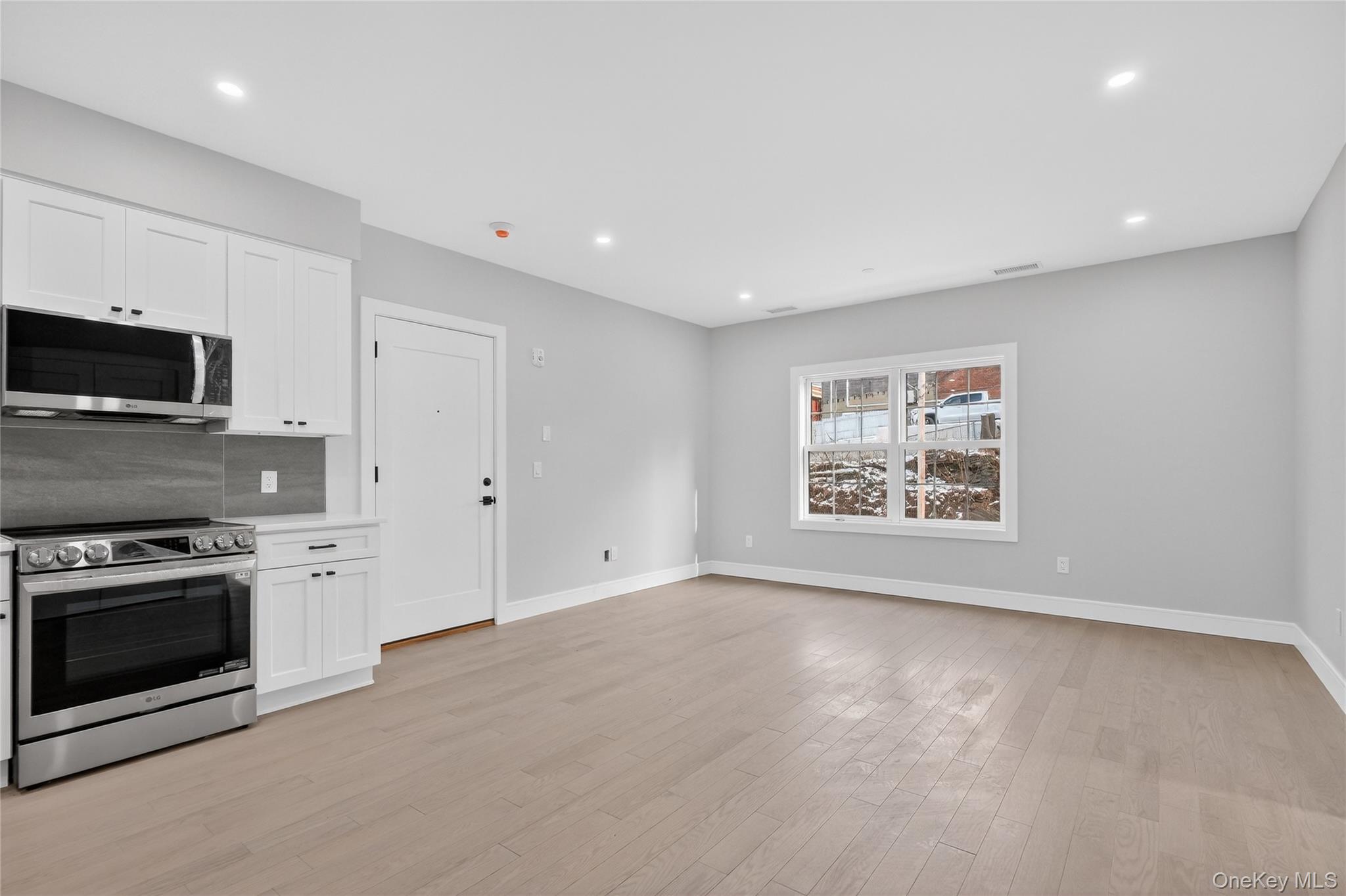 10 Market Street, Unit G Wappingers Falls, NY 12590 - Photo 5 of 20 a view of a kitchen with a stove cabinets and a wooden floor