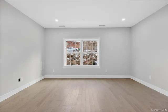 a view of room with window and hardwood floor