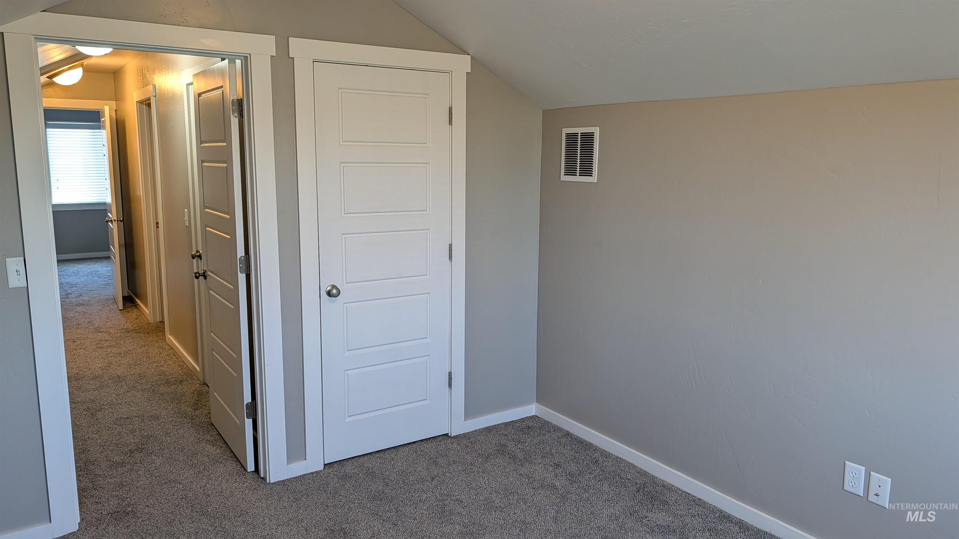 622 Lochsa Loop Heyburn, ID 83336 - Photo 15 of 17 Neutral tone wall paint with white trim, new carpeting, and modern paneled doors