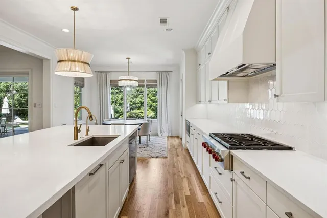 a kitchen with kitchen island a counter space a sink appliances and a counter top