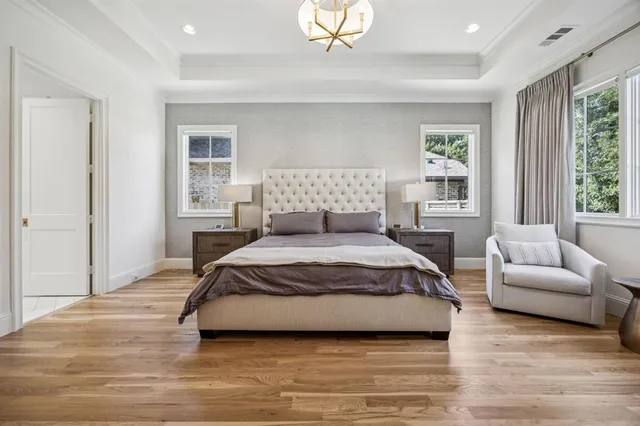 a spacious bedroom with a bed a couch and a window