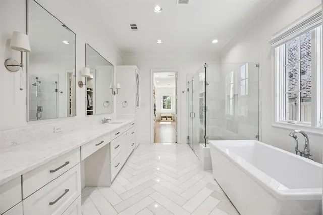 a spacious bathroom with a shower tub double sink and mirror
