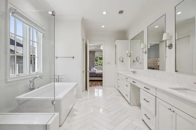 a spacious bathroom with a tub sink shower and mirror
