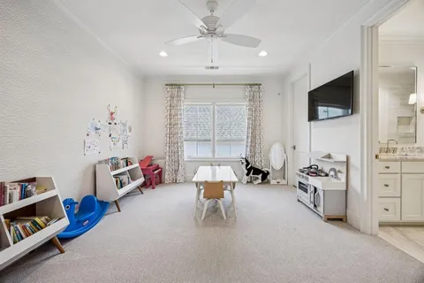 a bedroom with furniture and a flat screen tv