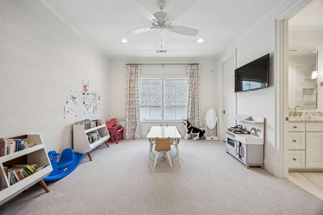a bedroom with furniture and a flat screen tv