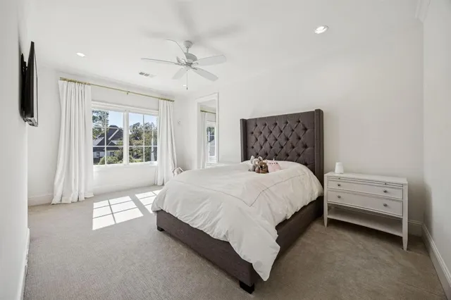 a bed sitting in a bedroom next to a window
