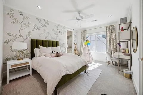 a bedroom with bed and a chandelier