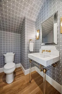 a bathroom with a sink toilet and mirror