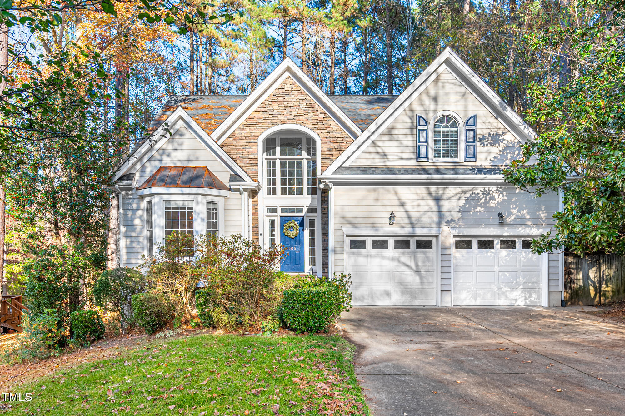 a front view of a house with a yard and lake view